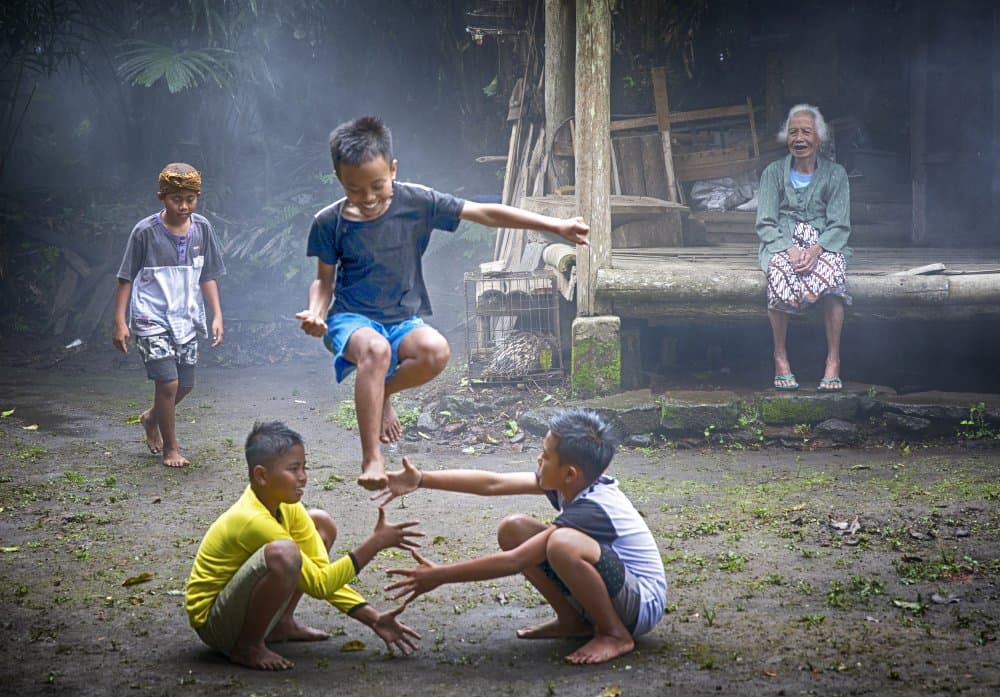 Village Kids Play by Angela Muliani Hartojo — canvas wall art