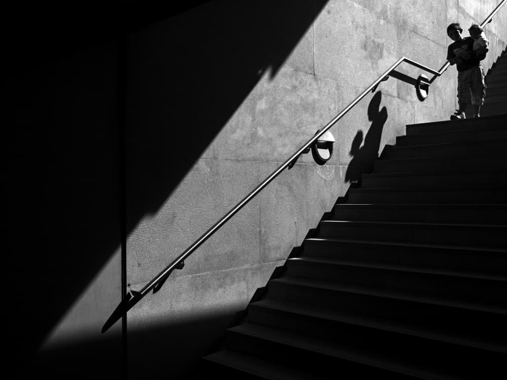Boy on Shadowy Stairs by Carlos Costa — canvas wall art