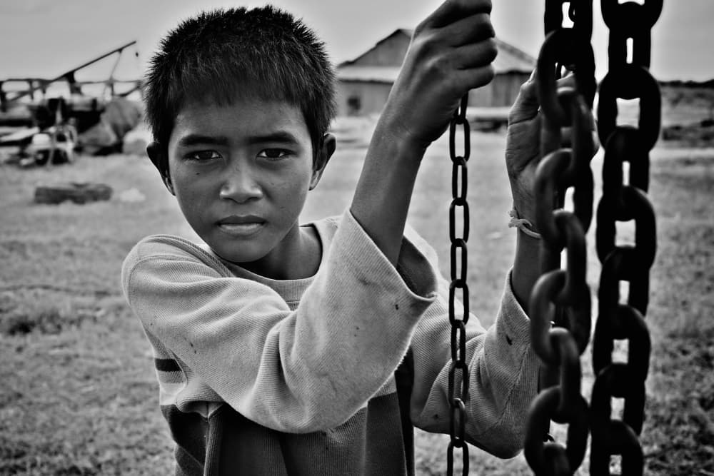 Serious Boy Holding Chains by Shinji Isobe — canvas wall art