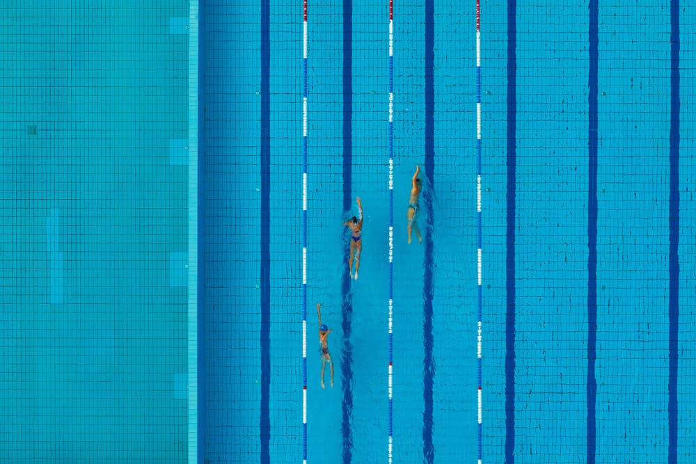 Overhead Pool Swimmers by Jure Kravanja — canvas wall art