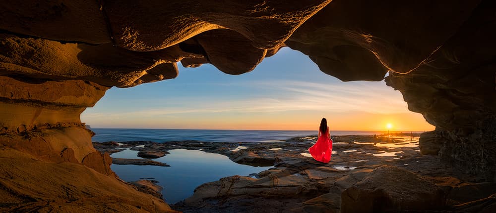 Woman Red Dress Cave Sunset by Jingshu Zhu — canvas wall art