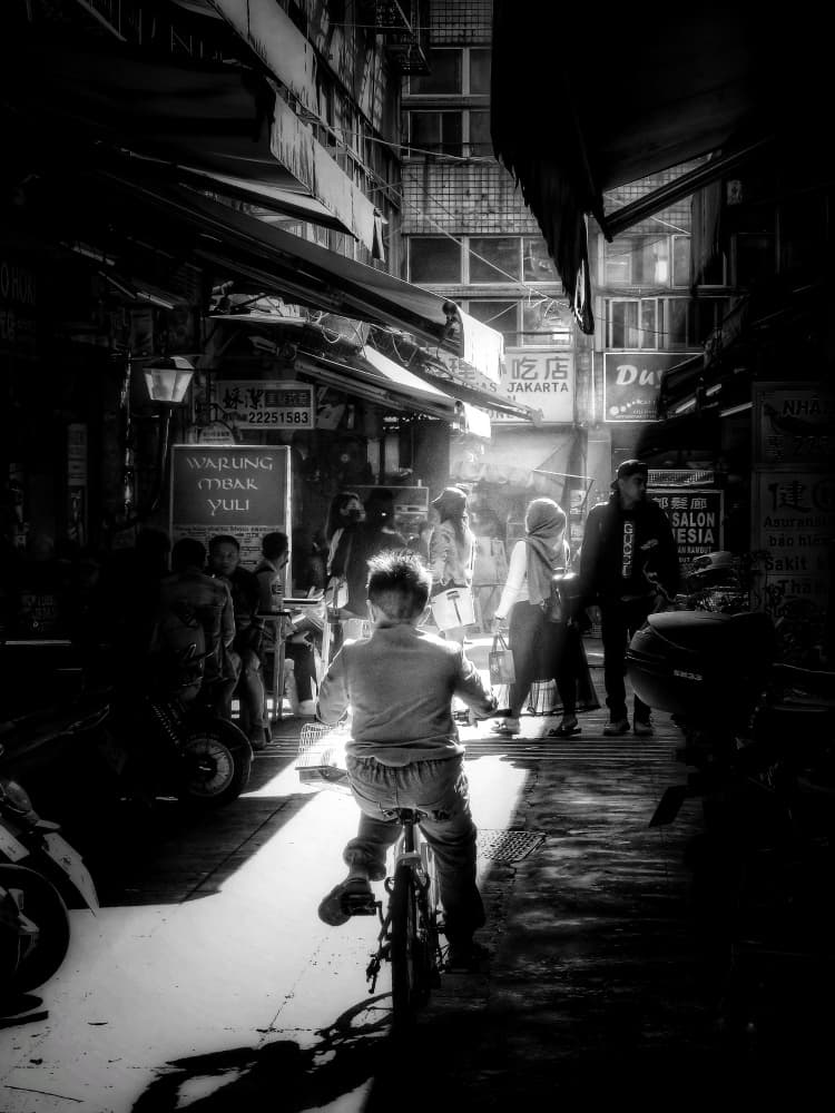 Boy's Sunlit City Ride by Yi-Tang Wang — canvas wall art