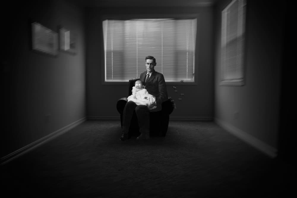 Somber Man and Baby by Ron Jones — canvas wall art