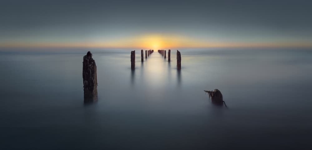 Ocean Pilings Sunset by Nadav Jonas — canvas wall art