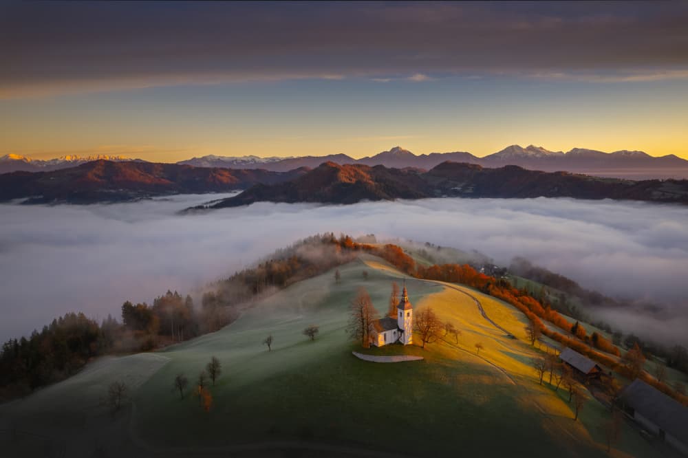 Church Above Foggy Valley by Ales Komovec — canvas wall art