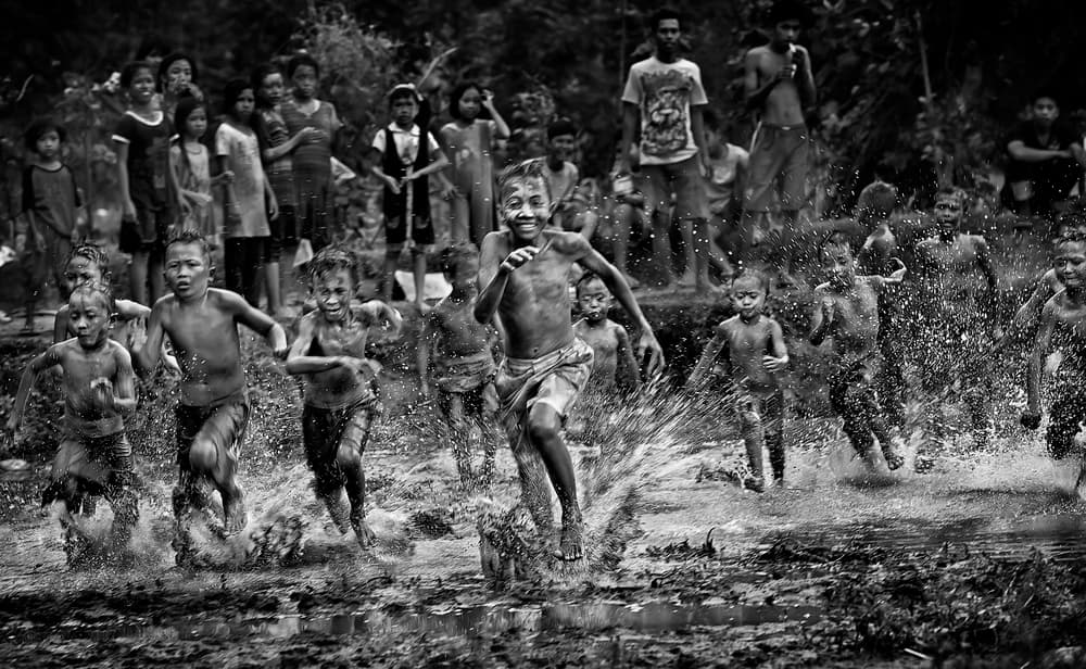 Joyful Children Splashing Race by Adhi Prayoga — canvas wall art