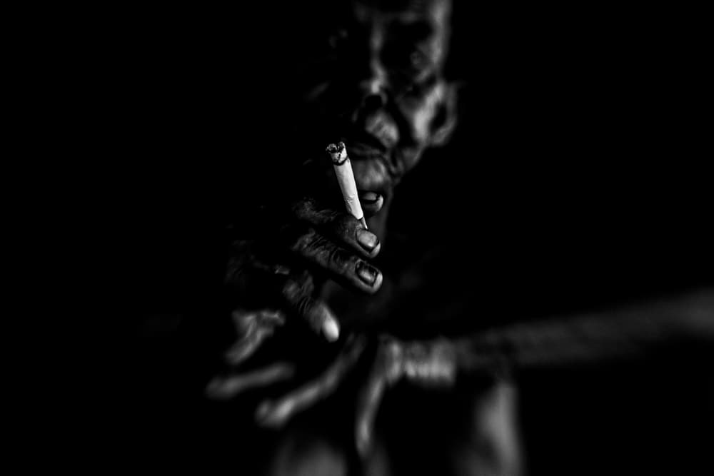 Dark Contemplative Smoking Hand by Andi Halil — canvas wall art