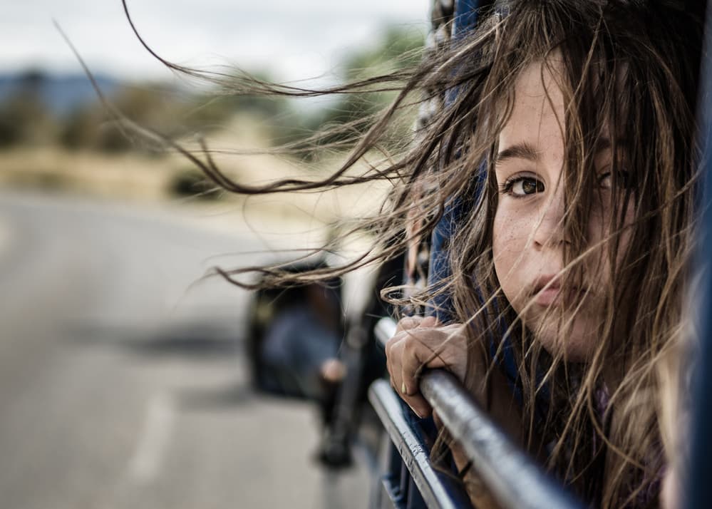 Windblown Child On Road by Tomasz Solinski — canvas wall art