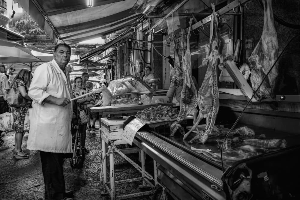 Market Butcher's Gaze by Michael Eßig — canvas wall art