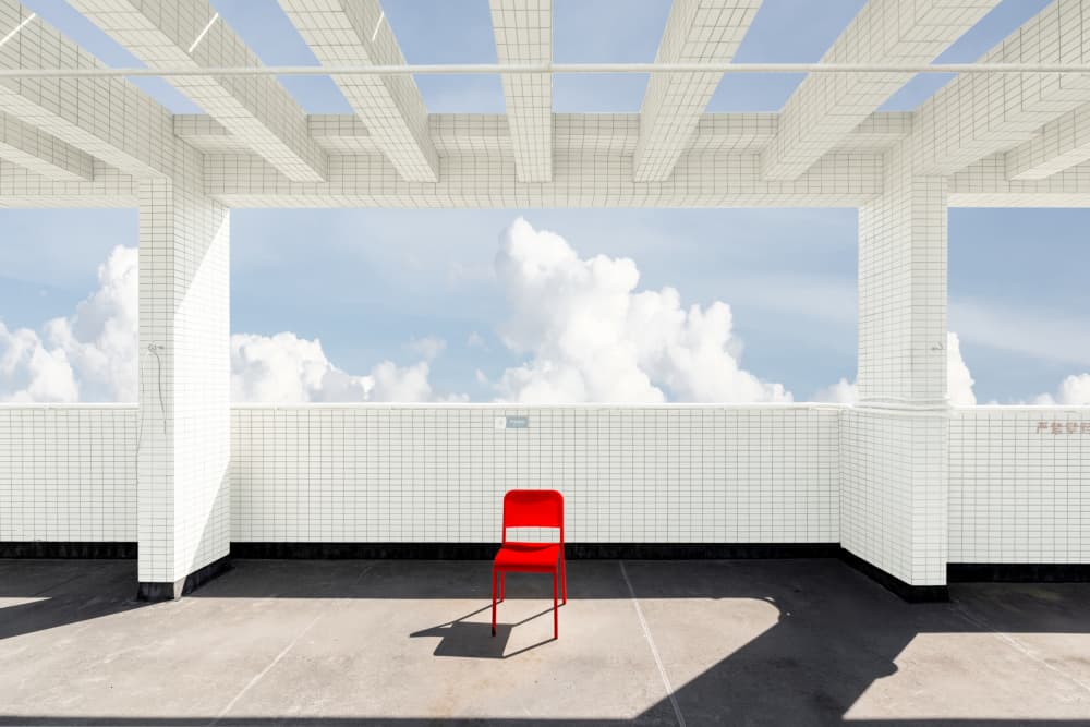 Red Chair on Rooftop by Xiaopeng Guan — canvas wall art
