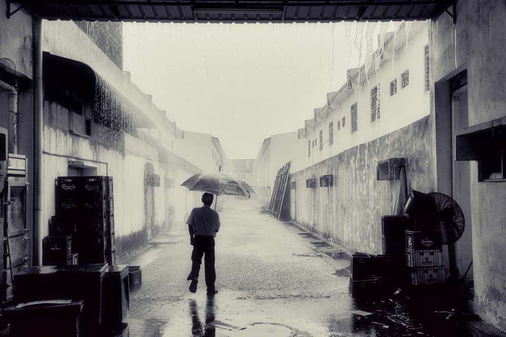 Man Walking in Rainy Alley by Peter Davidson — canvas wall art