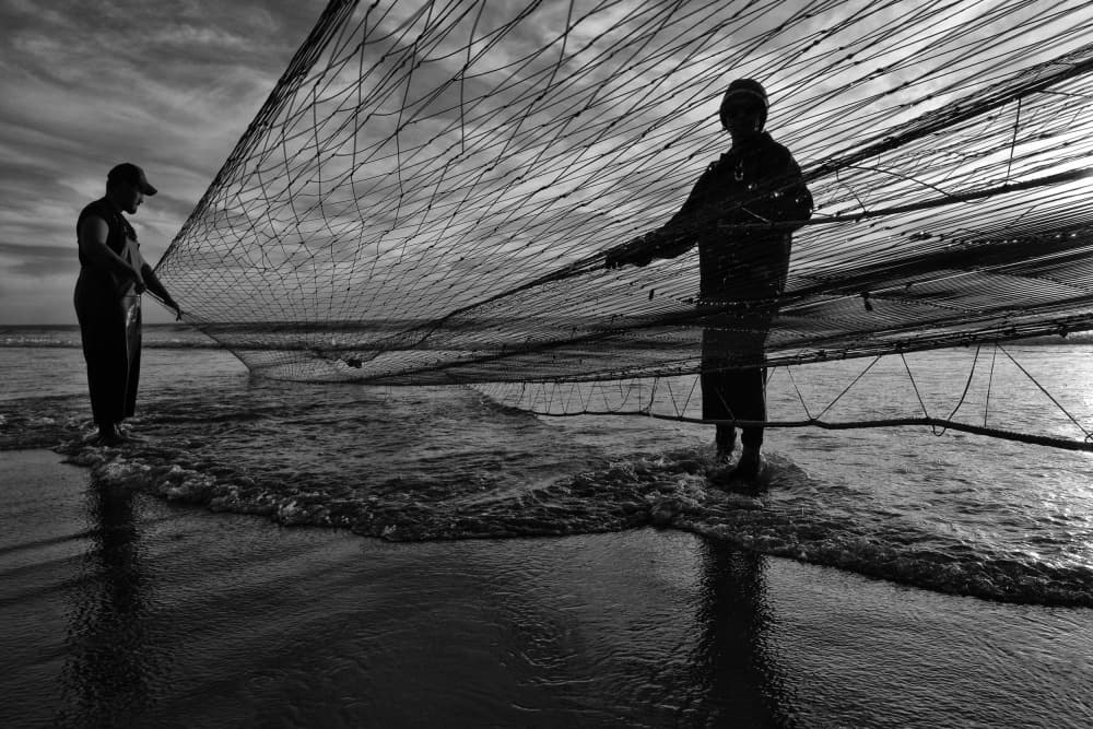 Silhouetted Fishermen Pulling Net by Josefina Melo — canvas wall art