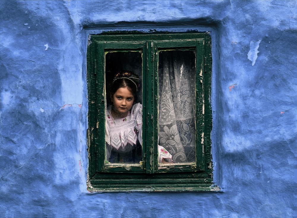 Girl In Blue Window by Irene Perovich — canvas wall art