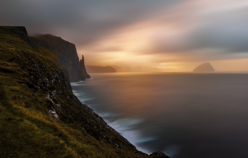 Dramatic Ocean Cliffs Glow by Jassi Oberai — canvas wall art