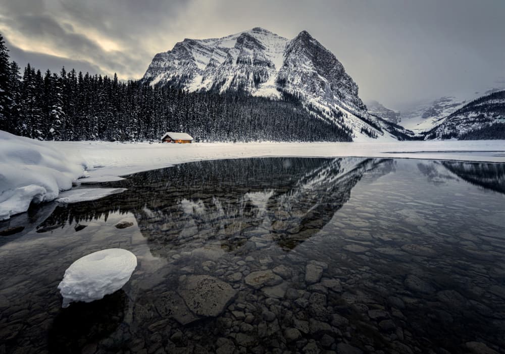 Snowy Mountain Lake Cabin by Ruiqing P. — canvas wall art