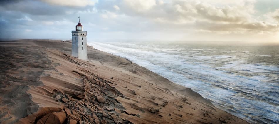 Lighthouse on Windswept Dunes