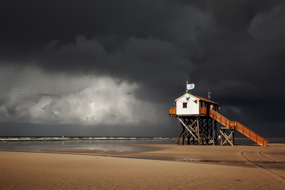 Stilt House Stormy Sky by Uschi Hermann — canvas wall art