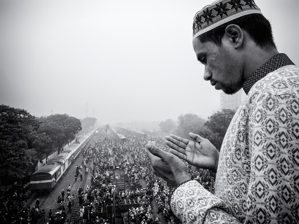 Man Praying Above Crowd by Marcel Rebro — canvas wall art