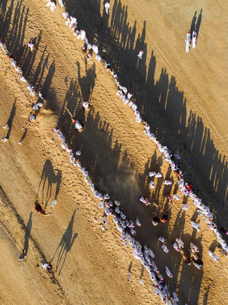 White Robes Desert Parade by Haitham AL Farsi — canvas wall art