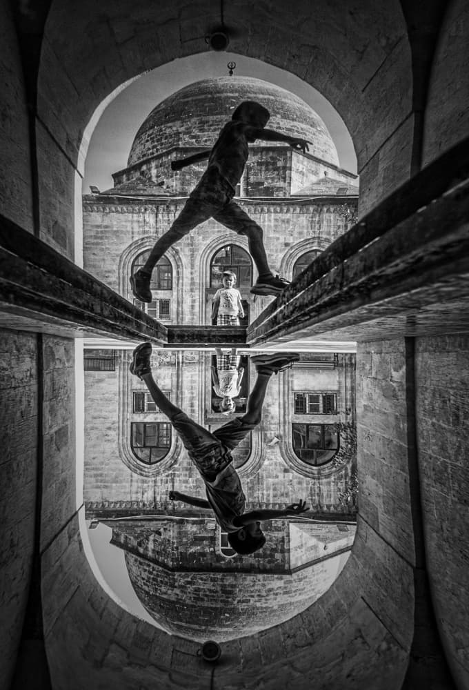 Boy's Reflected Leap by Babak Mehrafshar — canvas wall art