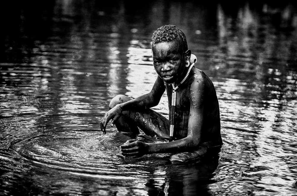 Tribal Boy In Water by Vedran Vidak — canvas wall art