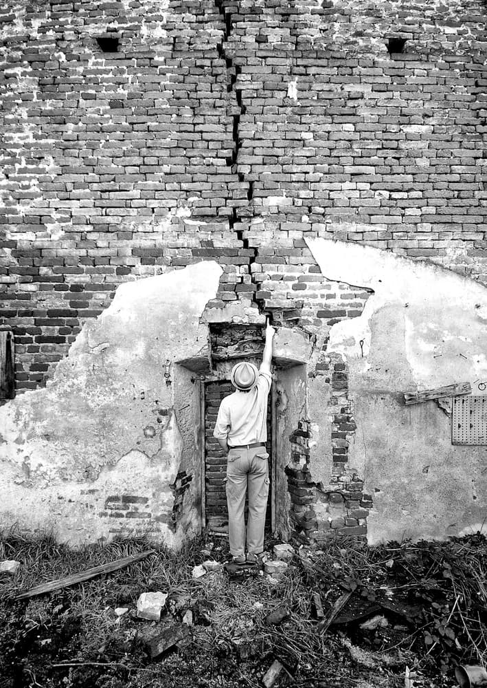 Man Inspects Cracked Wall by Carlo Ferrara — canvas wall art