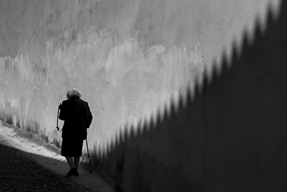 Elderly Woman Shadow Walk by Carlos Costa — canvas wall art