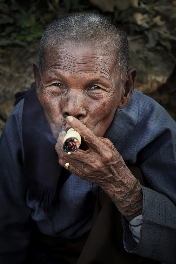 Wise Elder Smoking Cigar by Irene Perovich — canvas wall art