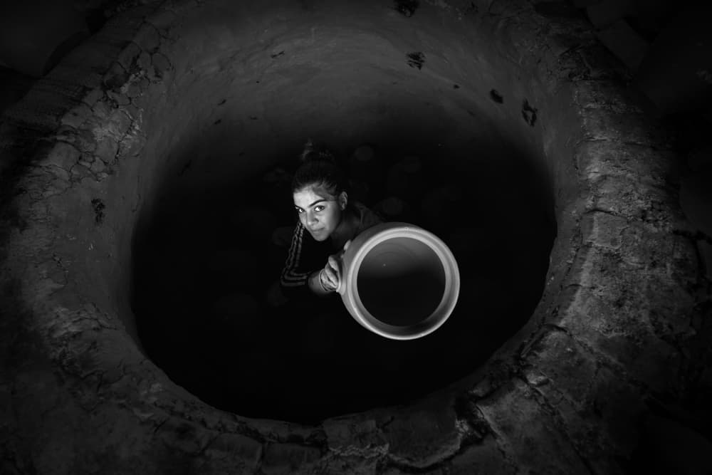 Woman in Deep Well by Veli Aydogdu — canvas wall art