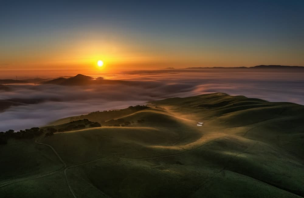 Sunrise Over Rolling Hills by Jenny Qiu — canvas wall art