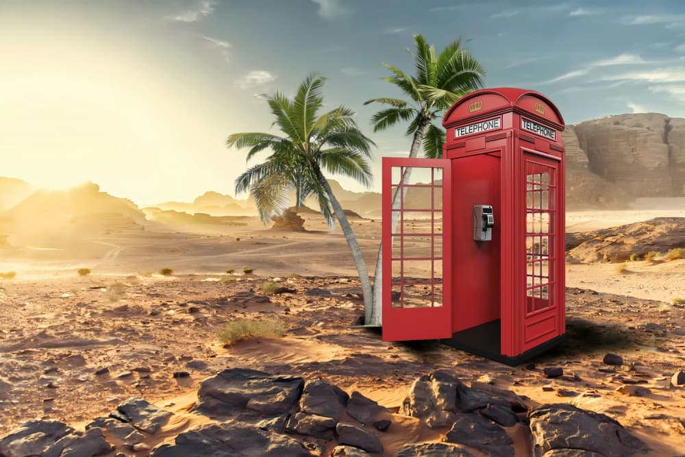 Red Phone Booth Desert Oasis by Rafal Kulik — canvas wall art