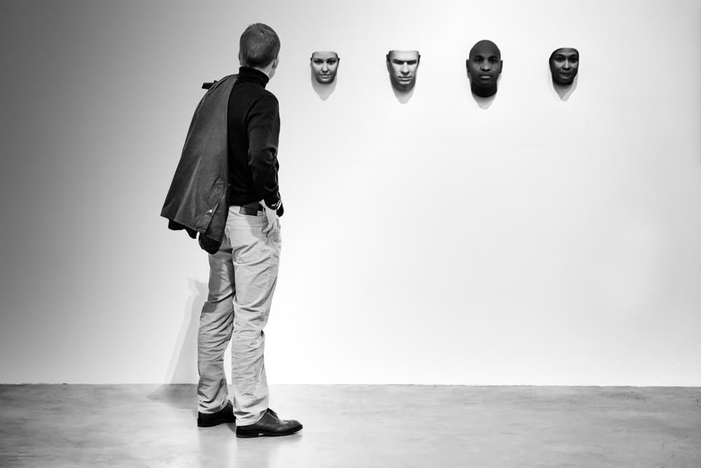 Man Contemplating Faces by Roswitha Schleicher-Schwarz — canvas wall art