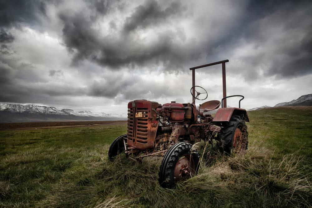 Rusty Tractor Stormy Sky by Þorsteinn H. Ingibergsson — canvas wall art