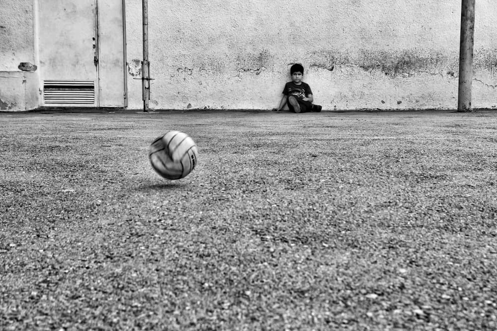 Boy with Ball Against Wall by Ali Ayer — canvas wall art