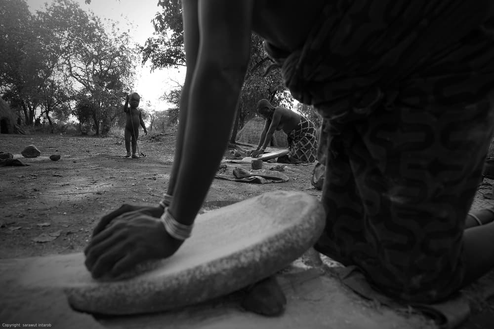 African Grinding Hands by Sarawut Intarob — canvas wall art