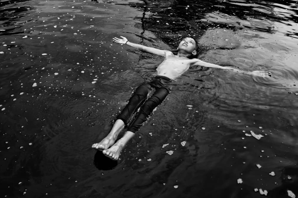 Floating Boy Serenity by Kieron Long — canvas wall art