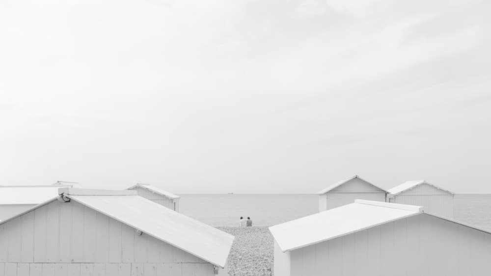 Serene White Beach Huts by Oskar Baglietto — canvas wall art