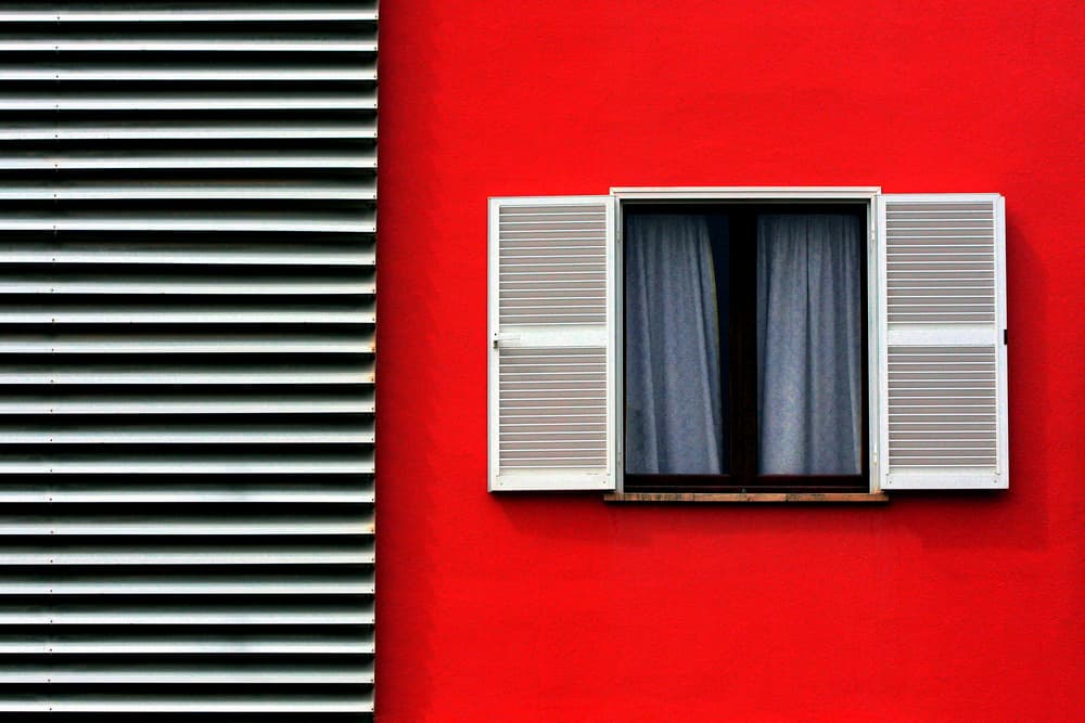 Red Wall White Shutters by Hans-Wolfgang Hawerkamp — canvas wall art