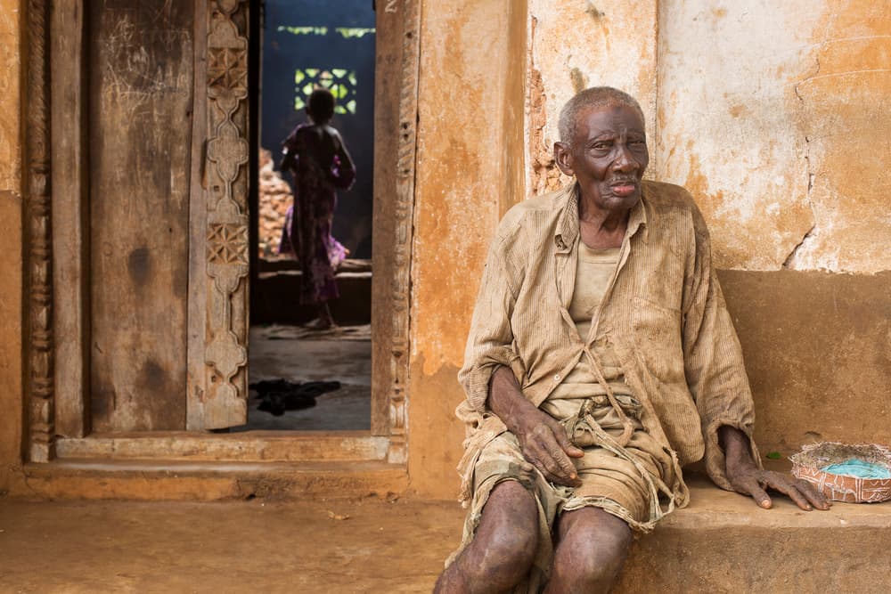 African Elder By Doorway by Dan Mirica — canvas wall art
