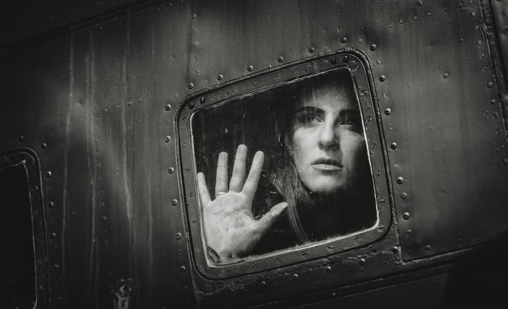 Woman Looking Out Window by Stefan Kamenov — canvas wall art