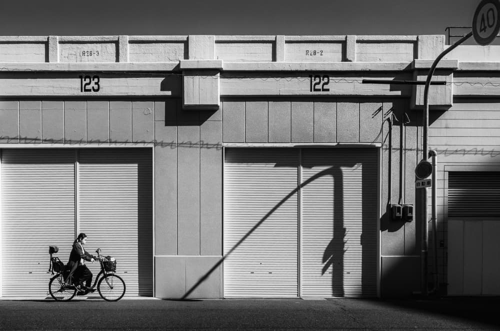 Lone Cyclist City Shadows by Haruyo Sakamoto — canvas wall art