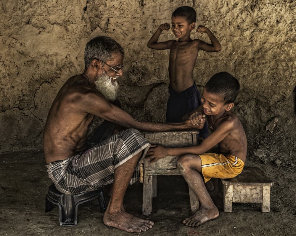 Family Arm Wrestling Fun by JAYATU CHANDRA DAS — canvas wall art