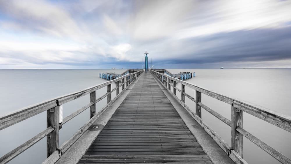 Moody Pier Over Calm Water by Rolf Lampert — canvas wall art