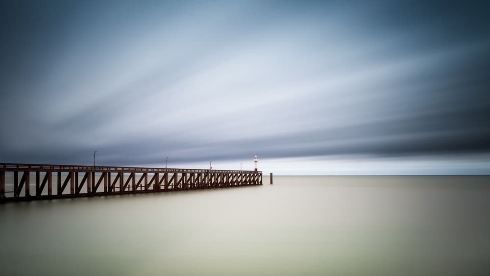 Moody Pier Horizon by Christophe Staelens — canvas wall art