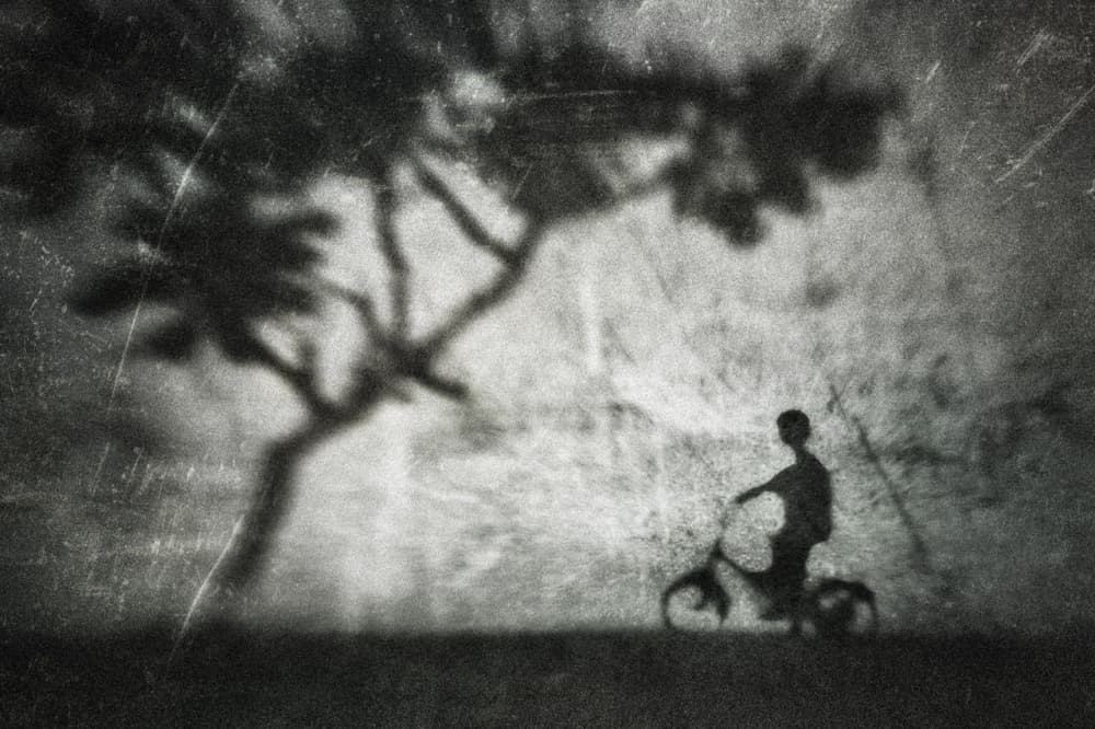 Boy on Bicycle Shadow by Suhandi Jitir — canvas wall art