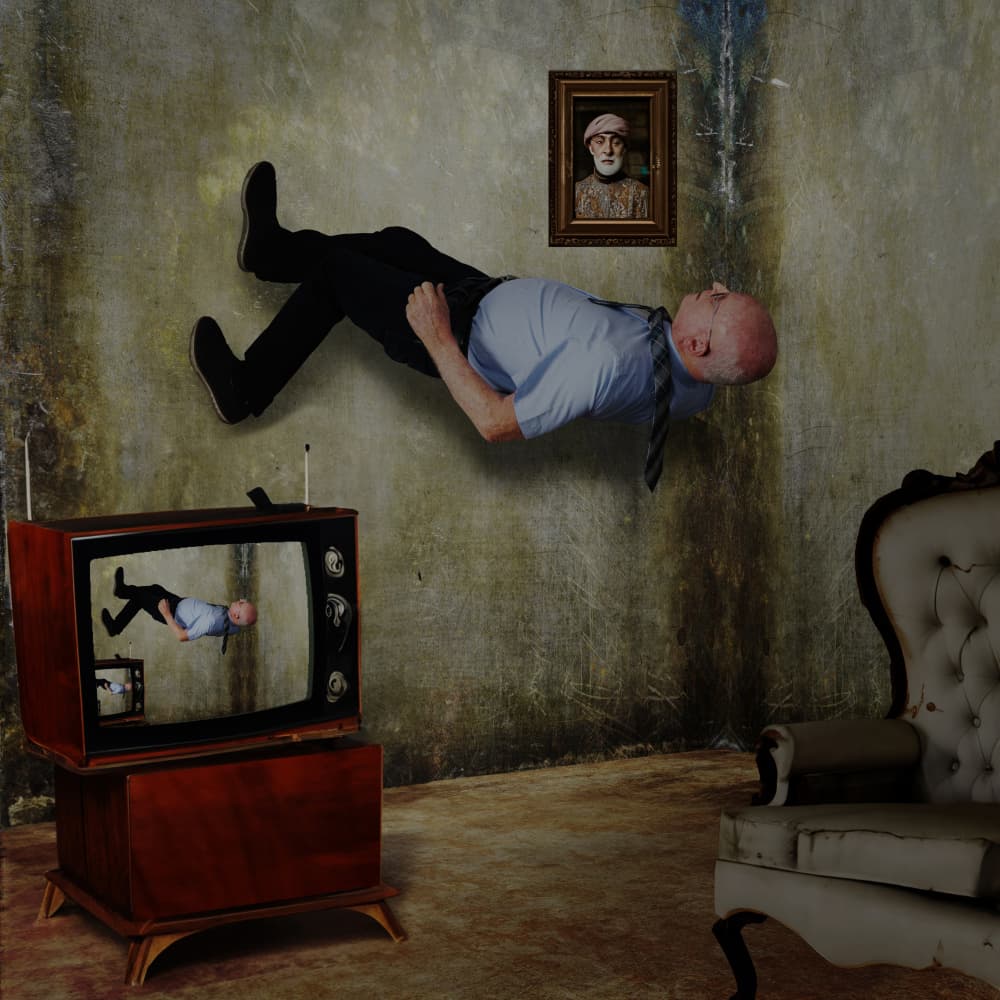 Weightless Man Watching TV by Dov Fuchs — canvas wall art