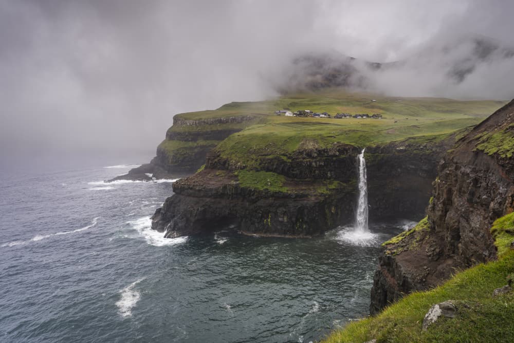 Misty Cliffs Waterfall Village by Greetje van Son — canvas wall art