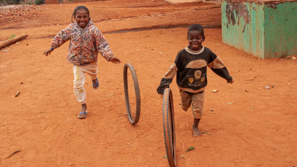 Joyful Kids Running Wheels by Henk Goossens — canvas wall art