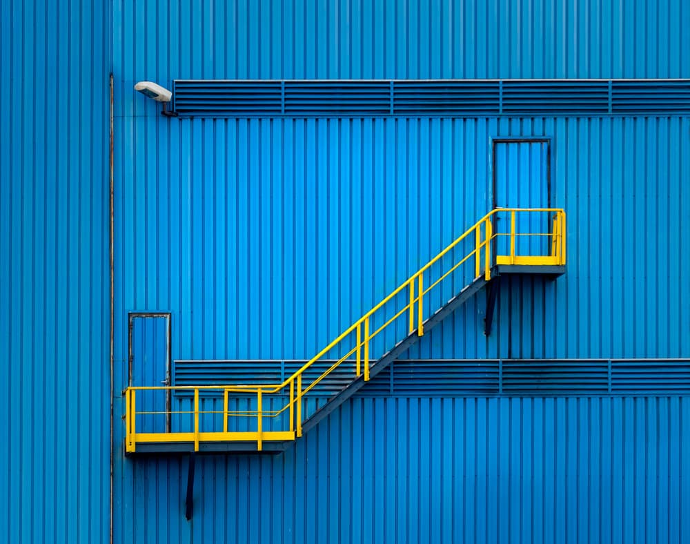 Blue Building Yellow Stairs by Alfonso Novillo — canvas wall art