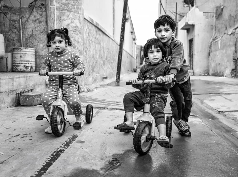 Joyful Street Tricycle Ride by Bashar Alsofey — canvas wall art